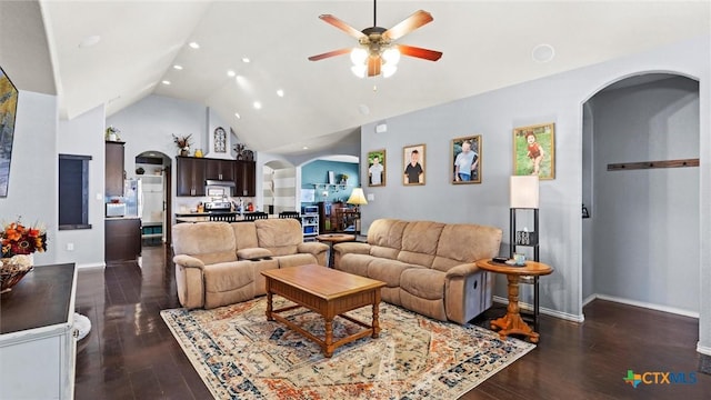 living room with ceiling fan, dark hardwood / wood-style flooring, and high vaulted ceiling