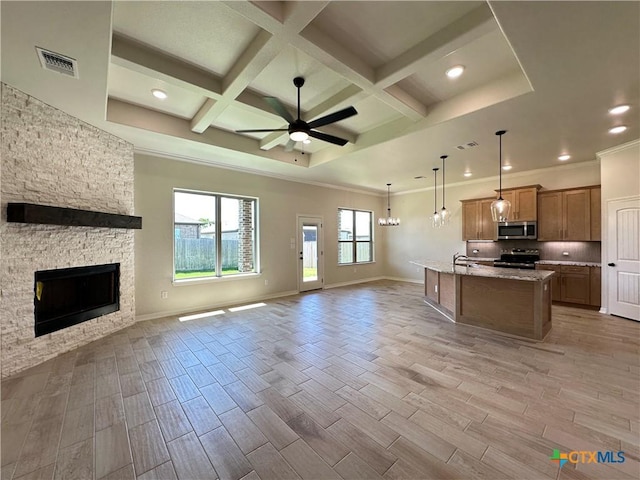 503 Magnolia Dr, Troy, TX 76579 - kitchen featuring appliances with stainless steel finishes, open floor plan, a ceiling fan, a stone fireplace, and coffered ceiling