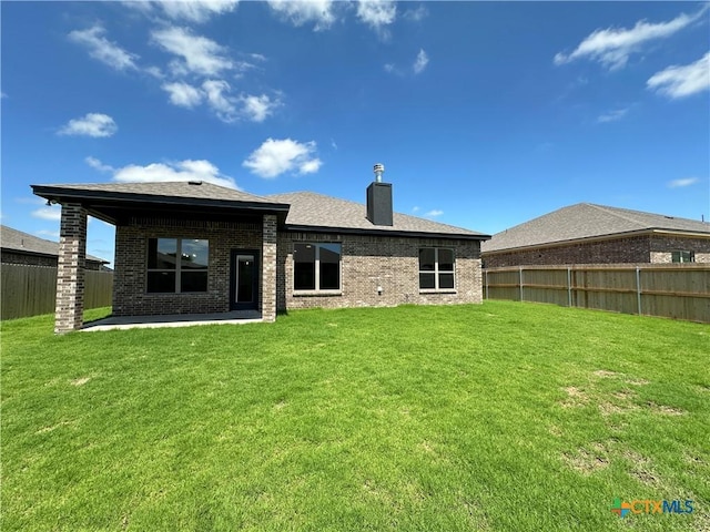 503 Magnolia Dr, Troy, TX 76579 - rear view of house with brick siding, a chimney, and a patio