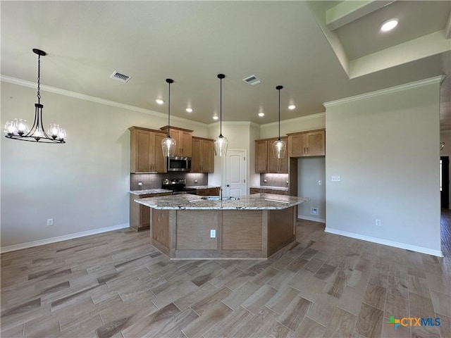 503 Magnolia Dr, Troy, TX 76579 - kitchen featuring appliances with stainless steel finishes, tasteful backsplash, brown cabinetry, recessed lighting, and a kitchen island with sink