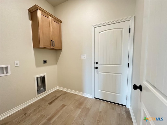 503 Magnolia Dr, Troy, TX 76579 - laundry room with electric dryer hookup, light wood-style flooring, cabinet space, and baseboards