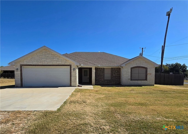 ranch-style home with a garage and a front lawn