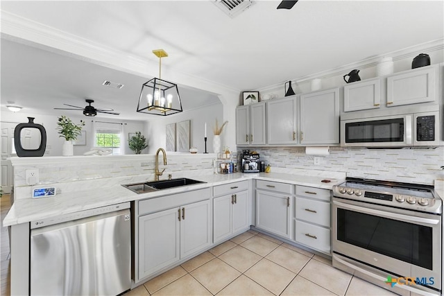 148 Willow Vw, Cibolo, TX 78108 - kitchen featuring appliances with stainless steel finishes, backsplash, a peninsula, light tile patterned floors, and crown molding