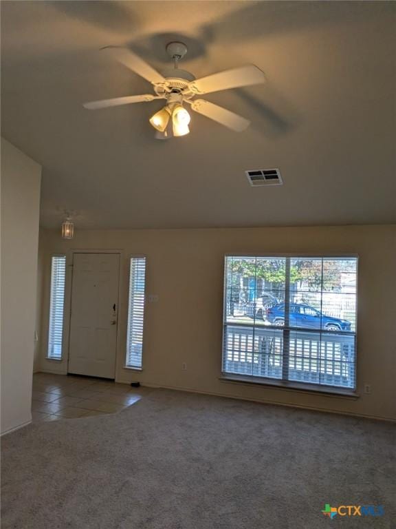 interior space featuring tile patterned floors and ceiling fan