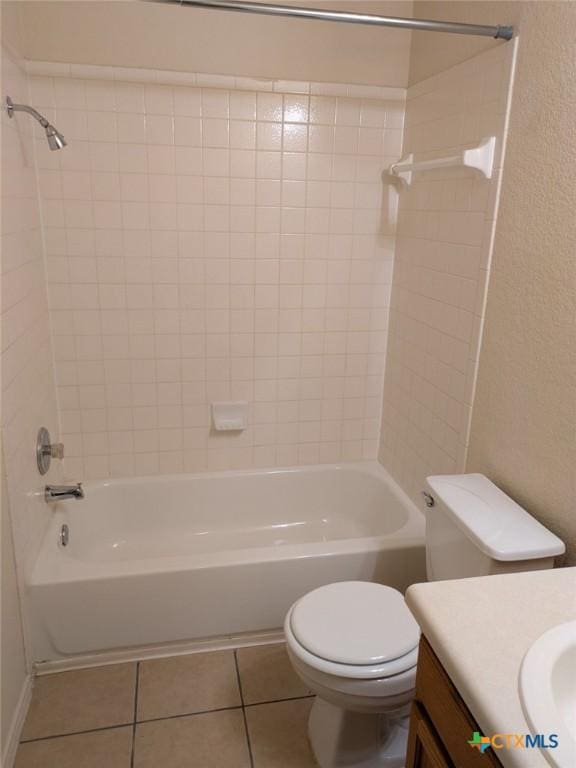 full bathroom with tile patterned floors, vanity, toilet, and tiled shower / bath