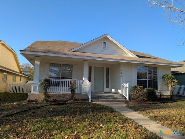 view of front of property with a front yard and covered porch