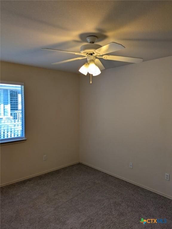 carpeted spare room featuring ceiling fan