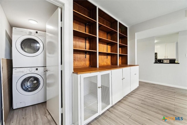3300 Yorktown St Unit 13, Houston, TX 77056 - laundry area with estacked washer and dryer and light wood finished floors