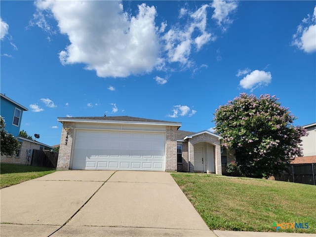 ranch-style home featuring a garage and a front lawn