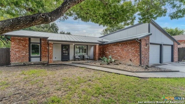 ranch-style house with a garage and a front yard