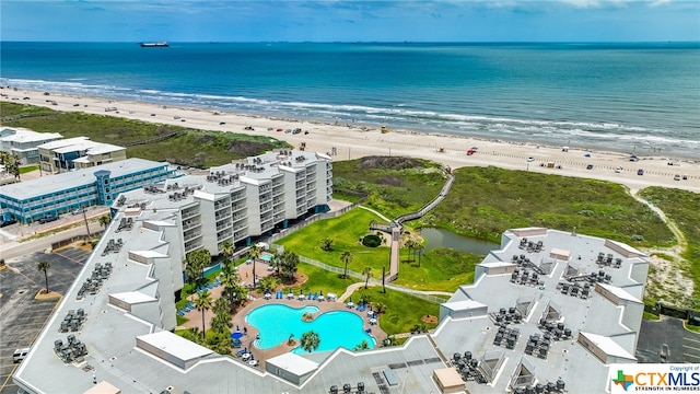 drone / aerial view featuring a beach view and a water view