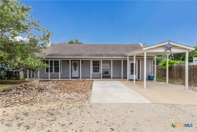 single story home featuring a porch and fence