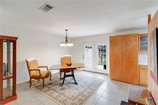 dining room featuring light tile patterned floors, an inviting chandelier, and visible vents