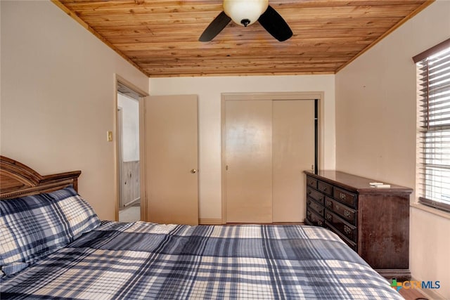 unfurnished bedroom featuring a closet, wood ceiling, ceiling fan, and vaulted ceiling