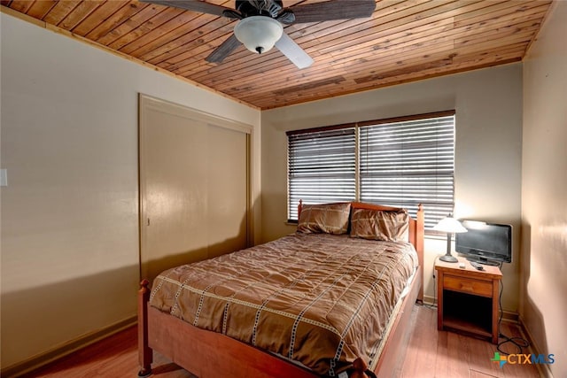 bedroom with a closet, wood ceiling, and wood finished floors