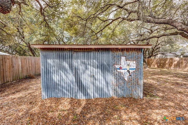 view of shed with a fenced backyard