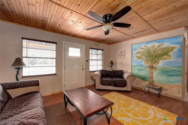 living room with baseboards, wood ceiling, wood finished floors, and ornamental molding