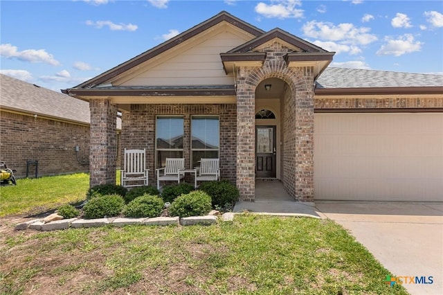 1401 Juneberry Park Dr, Temple, TX 76502 - view of front of property with driveway, brick siding, a front lawn, and a garage