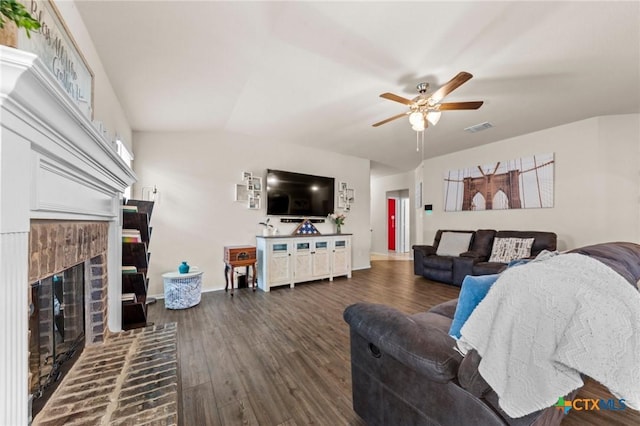 1401 Juneberry Park Dr, Temple, TX 76502 - living room with a ceiling fan, a brick fireplace, dark wood finished floors, and baseboards