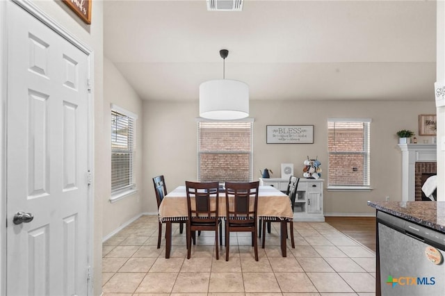 1401 Juneberry Park Dr, Temple, TX 76502 - dining room with light tile patterned floors, baseboards, and a brick fireplace
