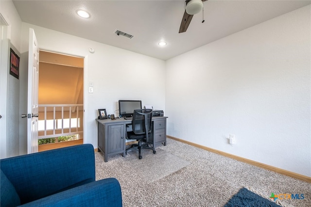 carpeted office space featuring ceiling fan