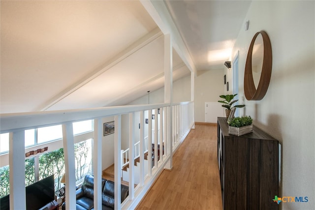 corridor featuring lofted ceiling with beams and light hardwood / wood-style floors