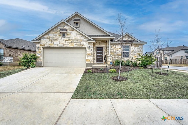 view of front of property with driveway, an attached garage, fence, a front lawn, and stucco siding