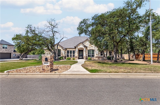 view of front facade with a garage and a front yard