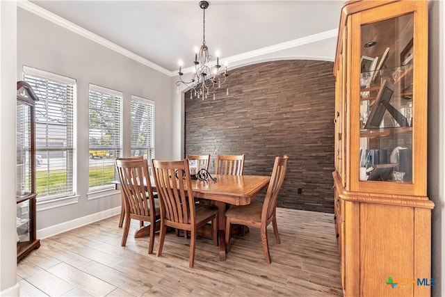 dining space with ornamental molding, plenty of natural light, and hardwood / wood-style flooring