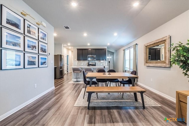 dining room featuring recessed lighting, visible vents, baseboards, and wood finished floors