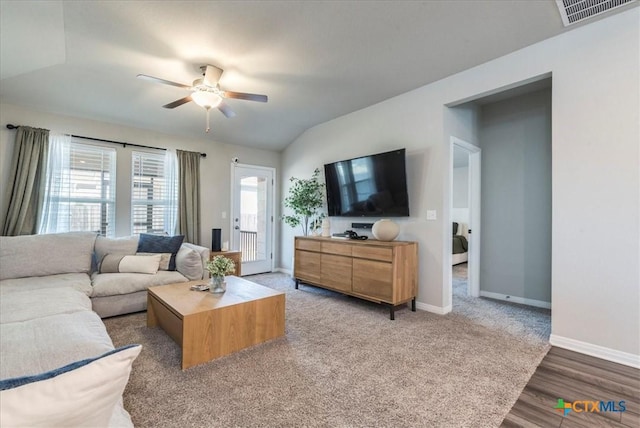 living area featuring a ceiling fan, lofted ceiling, visible vents, and baseboards