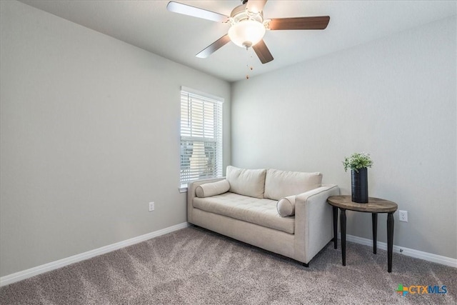 living area with carpet, baseboards, and ceiling fan