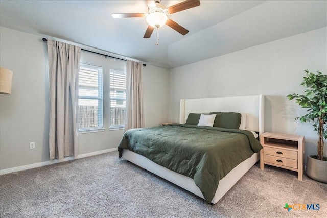 carpeted bedroom featuring vaulted ceiling, baseboards, and ceiling fan