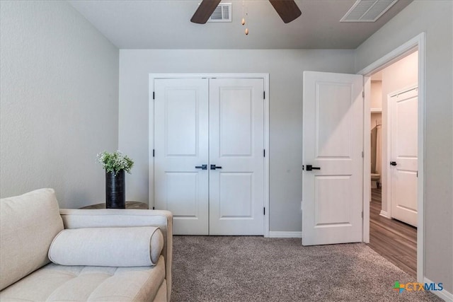 living area with a ceiling fan, baseboards, visible vents, and carpet flooring