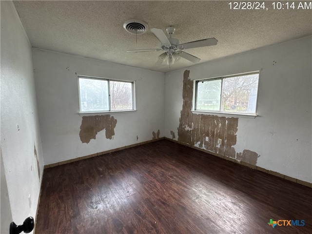 unfurnished room with ceiling fan, dark hardwood / wood-style flooring, and a textured ceiling