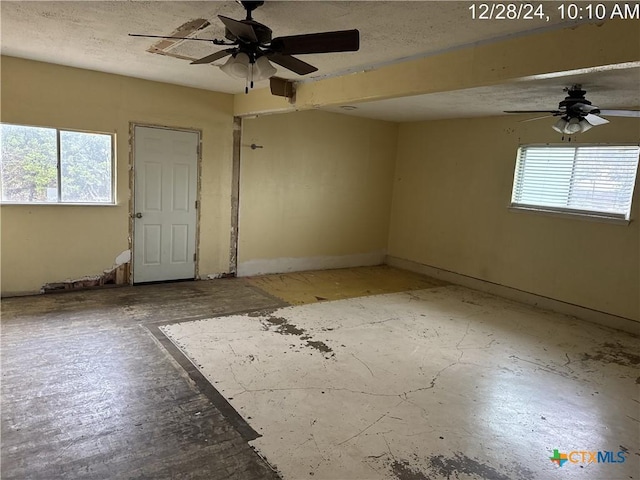 spare room with ceiling fan and a wealth of natural light