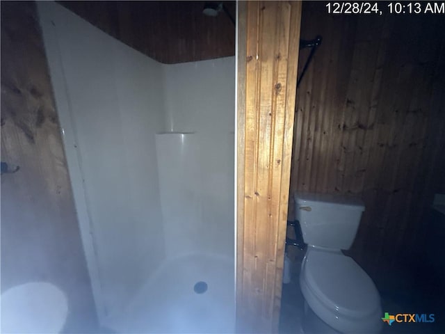 bathroom featuring toilet and walk in shower