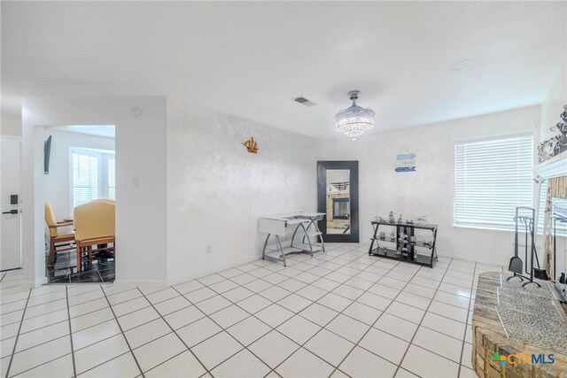2703 Schulze Dr, Killeen, TX 76549 - dining space with a fireplace with raised hearth, light tile patterned floors, and baseboards