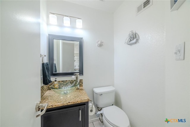 2703 Schulze Dr, Killeen, TX 76549 - half bathroom with vanity, toilet, tile patterned flooring, and decorative backsplash