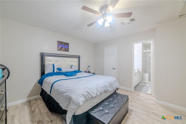 2703 Schulze Dr, Killeen, TX 76549 - bedroom featuring light wood finished floors, a textured ceiling, baseboards, ceiling fan, and ensuite bathroom