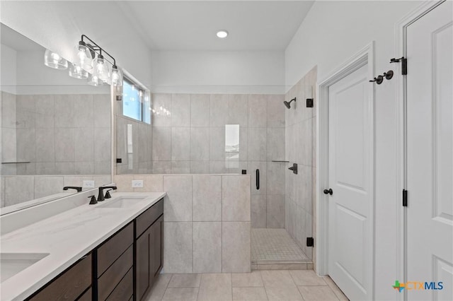 7915 Autumnwood Ln, Temple, TX 76502 - bathroom with a stall shower, double vanity, tile patterned flooring, and tile walls