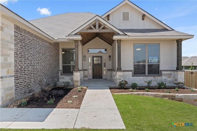 7915 Autumnwood Ln, Temple, TX 76502 - view of front of property with board and batten siding, a front yard, and stone siding