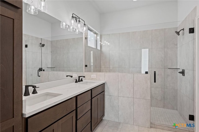 7915 Autumnwood Ln, Temple, TX 76502 - bathroom with a shower stall, double vanity, tile walls, and tile patterned flooring