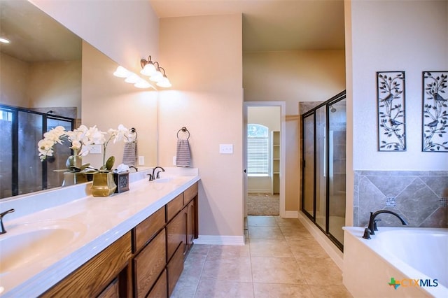 2601 Techny Dr, Harker Heights, TX 76548 - bathroom featuring double vanity, a garden tub, a shower stall, and tile patterned floors