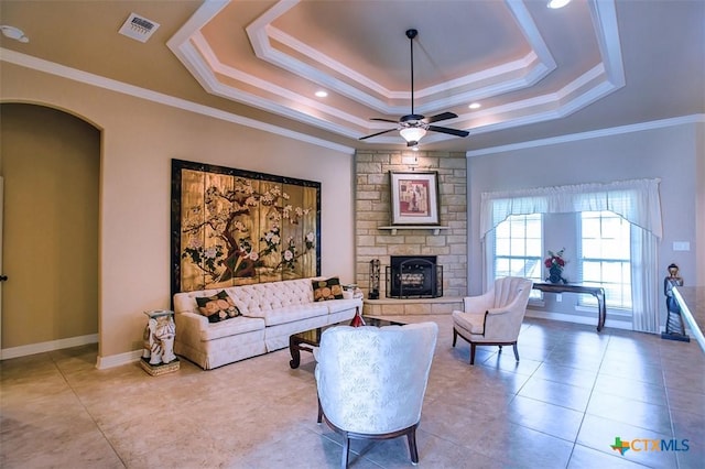 2601 Techny Dr, Harker Heights, TX 76548 - tiled living room with a tray ceiling, a fireplace, ornamental molding, and a ceiling fan