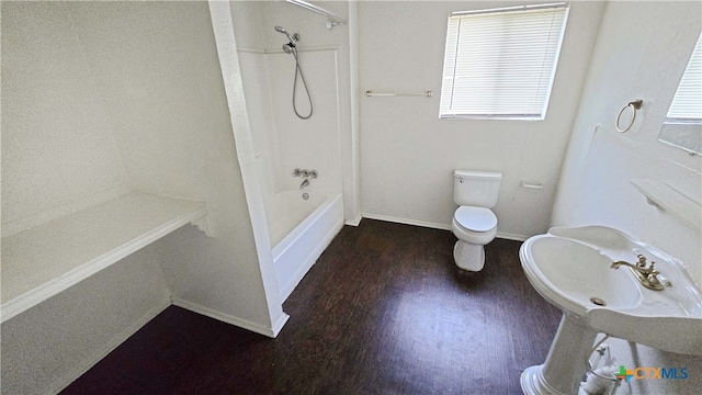 bathroom with toilet, bathtub / shower combination, and hardwood / wood-style flooring