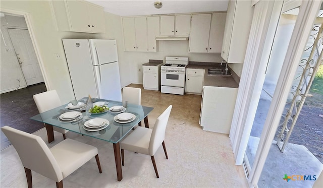 kitchen with white cabinets, white appliances, and sink