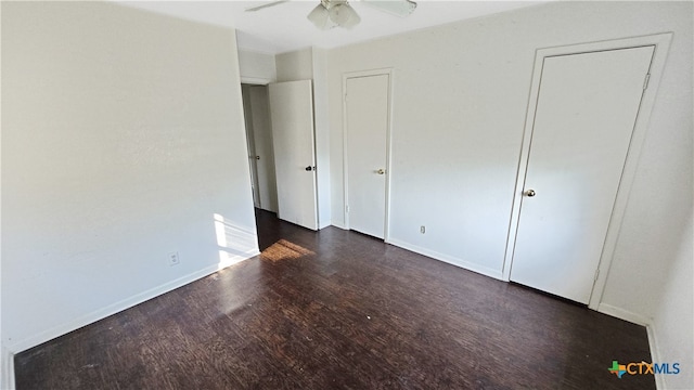 unfurnished bedroom with dark wood-type flooring and ceiling fan