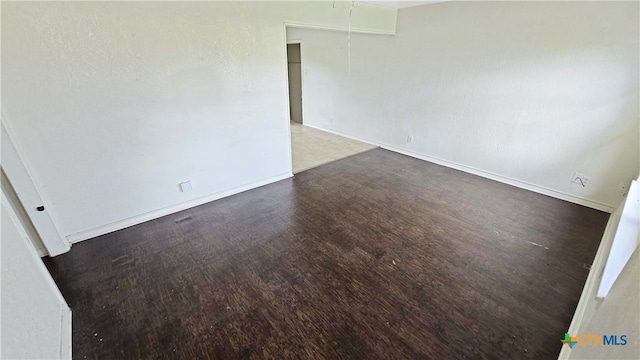 unfurnished room with dark hardwood / wood-style floors