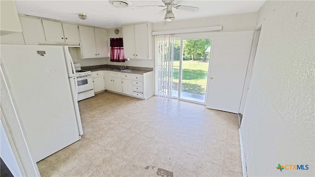 kitchen with white cabinetry, sink, white appliances, and ceiling fan